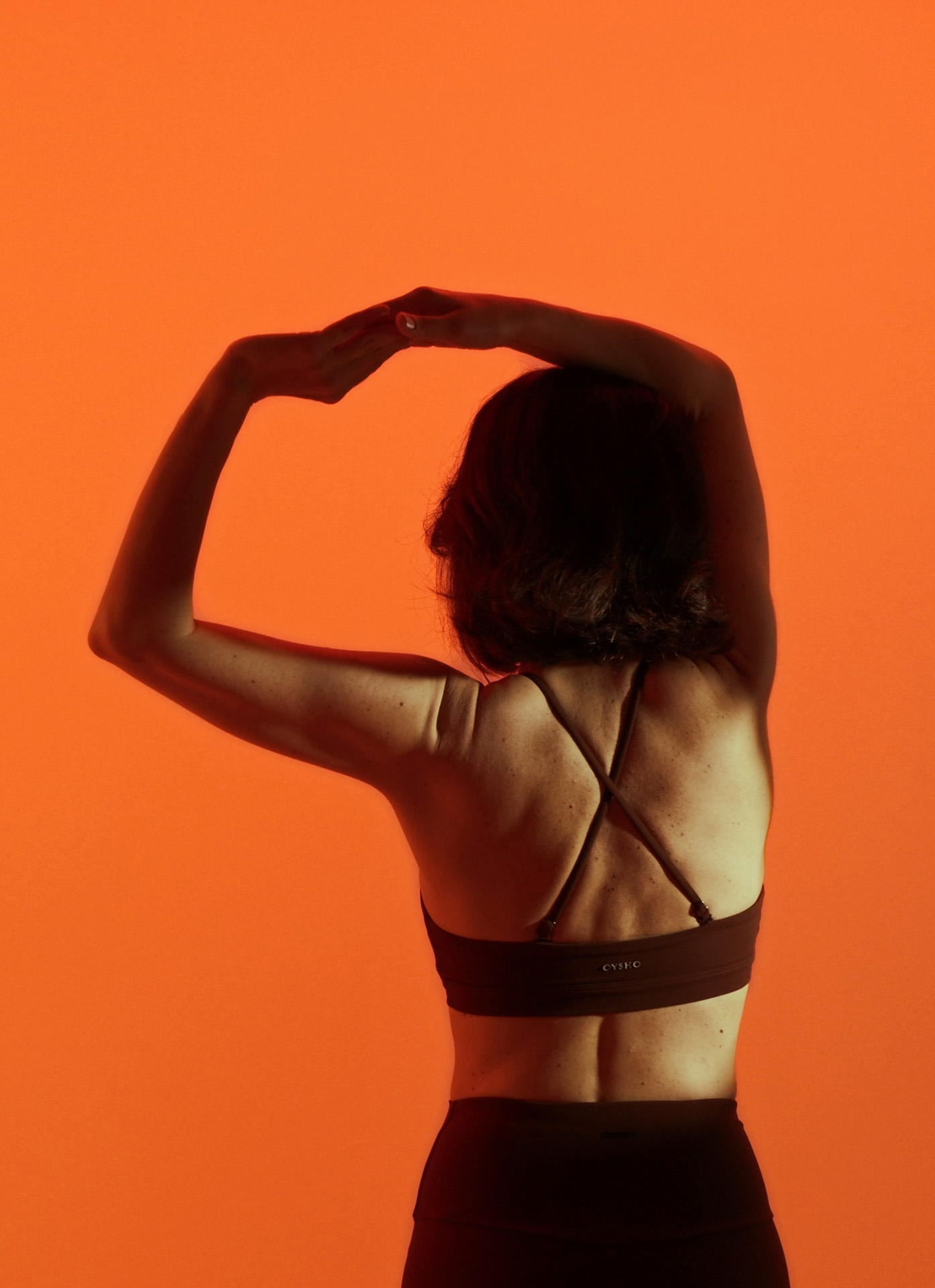 Standing side stretch with one arm curved over the head