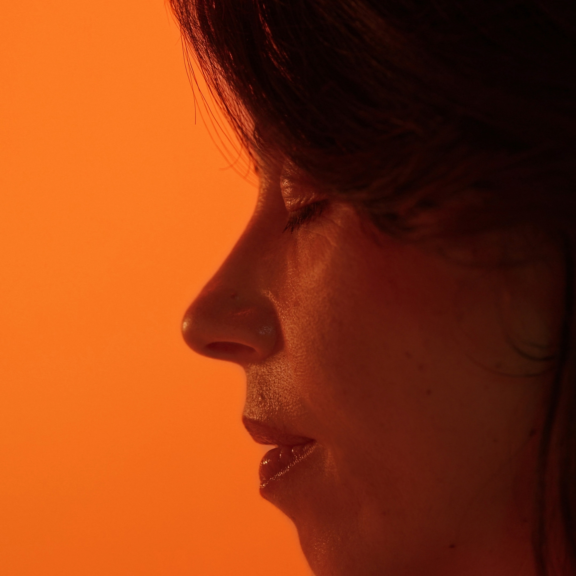 Profile of a woman with her eyes closed, taking a slow breath
